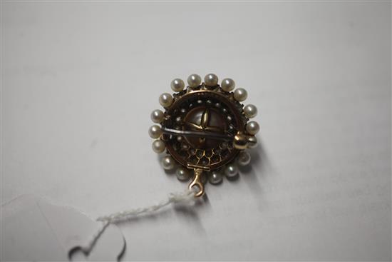 A late 19th/early 20th century American Theodore. B. Starr gold, cultured pearl and diamond set circular pendant brooch, 24mm.